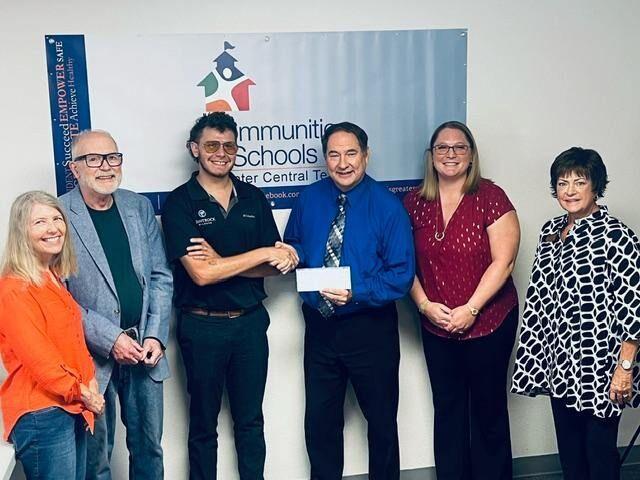 CIS receives $10,000 donation and school supply assistance